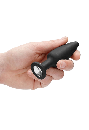 Podłużny, czarny plug z kryształkiem w podstawie