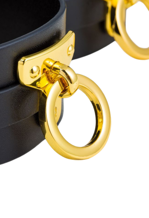Kajdanki na uda z czarnej skóry wykończone złotymi dodatkami